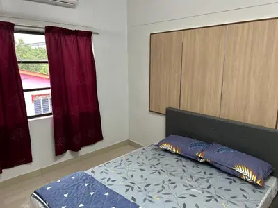 a bedroom with a bed and a window at Chengai homestay in Sungkai