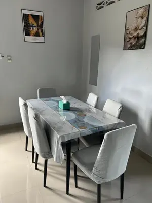 a dining room table with chairs and a blue table top at Chengai homestay in Sungkai
