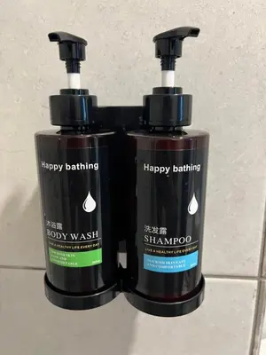 two bottles of hair products sitting on a tiled floor at Lavender Villa Marc Residence Bukit Mertajam in Bukit Mertajam