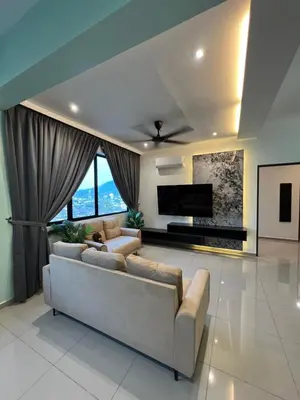 a living room with a couch and a tv at Lavender Villa Marc Residence Bukit Mertajam in Bukit Mertajam