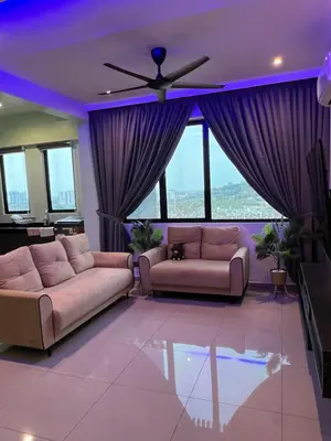 a living room with two couches and a ceiling fan at Lavender Villa Marc Residence Bukit Mertajam in Bukit Mertajam