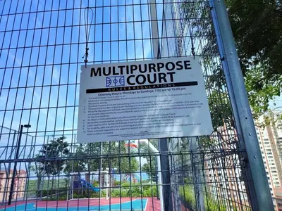 a sign on a fence that reads multipurchase eye court at The society Apartment George town 3br 10 pax in George Town
