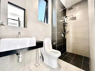 a bathroom with a sink and a toilet and a mirror at The society Apartment George town 3br 10 pax in George Town