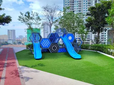 a playground in a park with a blue slide at The society Apartment George town 3br 10 pax in George Town