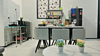 a kitchen with a table and chairs in a room at The society Apartment George town 3br 10 pax in George Town