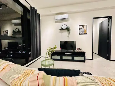 a living room with a couch and a tv at Sea & City View New Condo in Georgetown 3br 10 pax in George Town