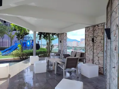 a patio with white furniture and a view of the city at Sea & City View New Condo in Georgetown 3br 10 pax in George Town
