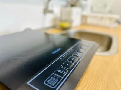 a remote control sitting on a counter next to a sink at Sea & City View New Condo in Georgetown 3br 10 pax in George Town