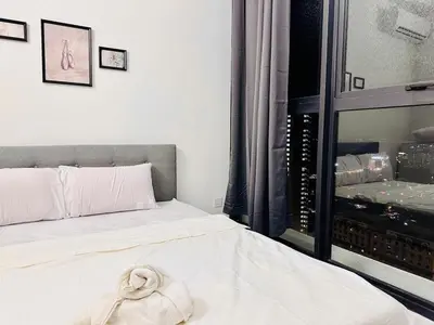a bedroom with a bed with a towel on it at Sea & City View New Condo in Georgetown 3br 10 pax in George Town