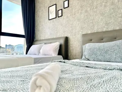two beds sitting next to each other in a bedroom at Classic House in Georgetown 3BR 10pax in George Town