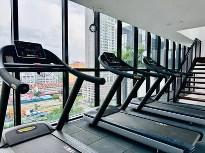 a row of treadmills in a gym with a window at Classic House in Georgetown 3BR 10pax in George Town
