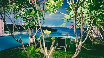 a view from the garden of a resort with a table and chairs at Classic House in Georgetown 3BR 10pax in George Town