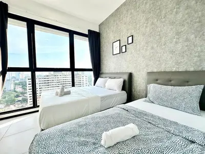 two beds in a room with a large window at Groups & Families Spacious Infinity Pool 3br 10pax in George Town