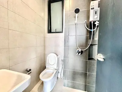 a bathroom with a toilet and a sink and a mirror at Groups & Families Spacious Infinity Pool 3br 10pax in George Town