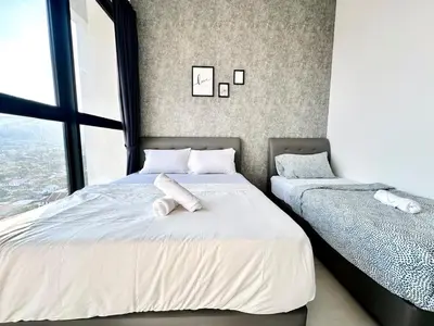 two beds in a room with windows at Groups & Families Spacious Infinity Pool 3br 10pax in George Town