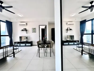 a living room with a table and chairs and windows at Groups & Families Spacious Infinity Pool 3br 10pax in George Town