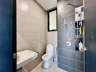 a small bathroom with a toilet and a shower at World Class Apartment In Georgetown 3BR 10 pax in George Town
