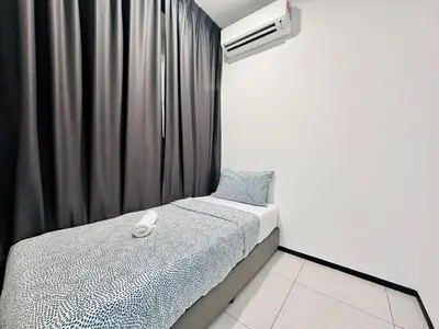 a small bedroom with a bed and a air conditioner at World Class Apartment In Georgetown 3BR 10 pax in George Town