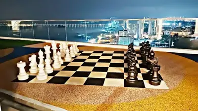 a chess board on a table with a view of a city at World Class Apartment In Georgetown 3BR 10 pax in George Town