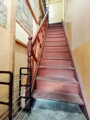 a flight of stairs in an office building at \u90a6\u54af\u5c9b\u6f2b\u753b\u6c11\u5bbf in Pangkor
