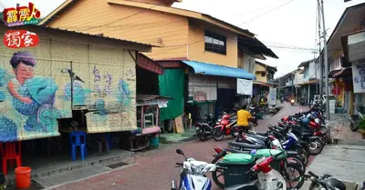 a group of motorcycles parked on a city street at \u90a6\u54af\u5c9b\u6f2b\u753b\u6c11\u5bbf in Pangkor