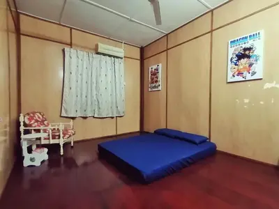 a bedroom with a blue bed and a window at \u90a6\u54af\u5c9b\u6f2b\u753b\u6c11\u5bbf in Pangkor