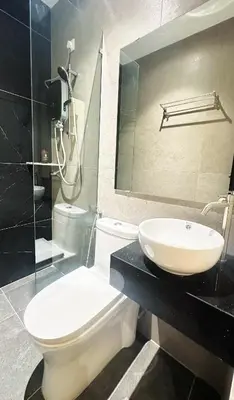 a bathroom with a toilet and a sink and a shower at Legend Inn Sungai Petani in Sungai Petani