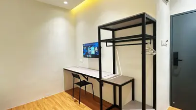 a room with a desk with a computer on it at Legend Inn Sungai Petani in Sungai Petani