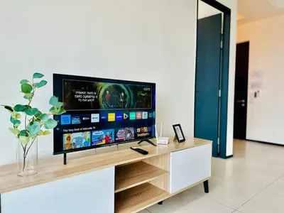 a flat screen tv sitting on top of a table at cozy family stay suites apartment 3br 10 pax in George Town