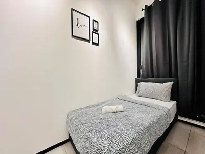 a bedroom with a bed with a black curtain at cozy family stay urban suite 3br 10 pax in George Town