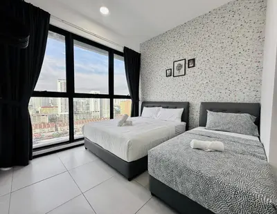 a bedroom with two beds and a large window at cozy family stay urban suite 3br 10 pax in George Town