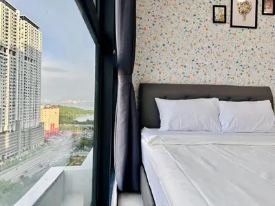 a bedroom with a bed with a view of a city at cozy family stay urban suite 3br 10 pax in George Town