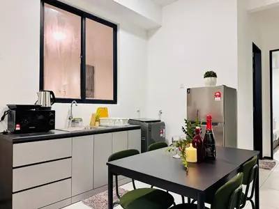 a kitchen with a table with bottles of wine on it at luxury apartment 3br 10 pax in George Town