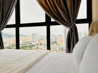 a bedroom with a white bed and a window at luxury apartment 3br 10 pax in George Town