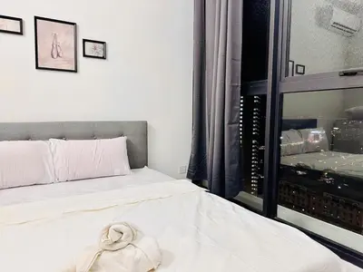 a bedroom with a bed with a towel on it at luxury apartment 3br 10 pax in George Town