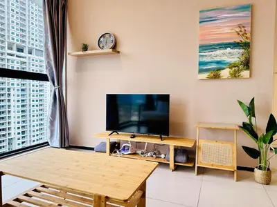 a living room with a tv and a table at luxury apartment 3br 10 pax in George Town