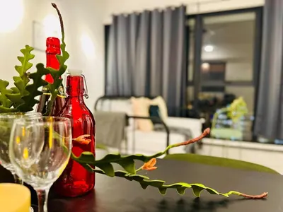 a table with two bottles and a wine glass at luxury apartment 3br 10 pax in George Town