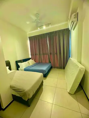 a hotel room with two beds and a window at Infinity pool luxury apartment suites 3br 10 pax in George Town
