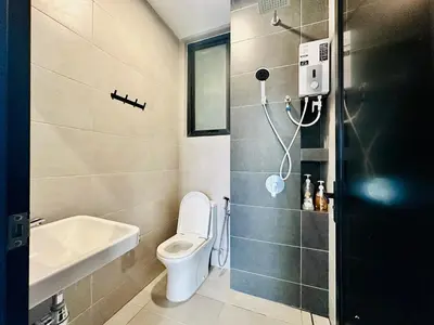 a bathroom with a toilet and a sink at Infinity pool luxury apartment suites 3br 10 pax in George Town
