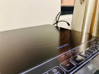 a laptop computer sitting on top of a microwave at Infinity pool luxury apartment suites 3br 10 pax in George Town