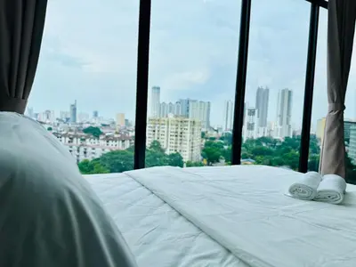 a hotel room with a bed and a view of a city at Infinity pool luxury apartment suites 3br 10 pax in George Town