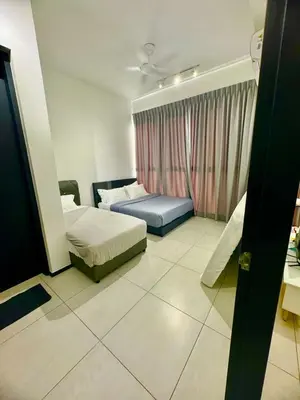 a hotel room with two beds and a window at Infinity pool luxury apartment suites 3br 10 pax in George Town
