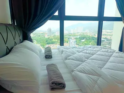 a bed in a room with a large window at Infinity pool luxury apartment suites 3br 10 pax in George Town