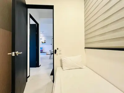 a bedroom with a bed and a open door at 15 min airport to apartment 3br 10pax in George Town