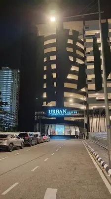 a building with cars parked in a parking lot at night at 15 min airport to apartment 3br 10pax in George Town