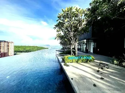 a body of water with trees and a building at 15 min airport to apartment 3br 10pax in George Town