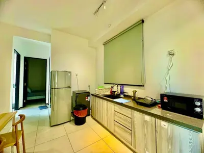 a kitchen with a large screen on the wall at 15 min airport to apartment 3br 10pax in George Town