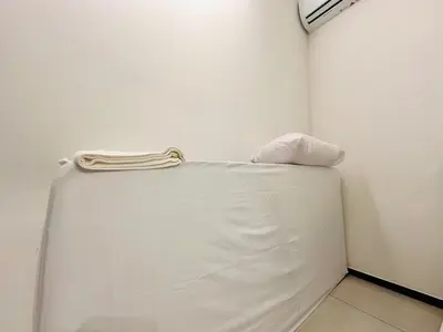 a white bed in a corner of a room at UB suite aparment for food hunter 3br 10 pax in George Town