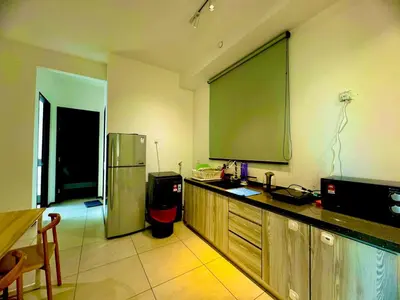 a kitchen with a large green screen on the wall at UB suite aparment for food hunter 3br 10 pax in George Town
