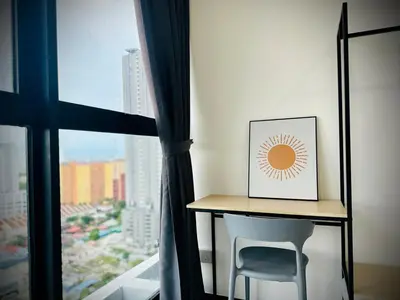 a desk with a picture and a chair next to a window at Near komtar apartment in goergetown 3br 10 pax in George Town